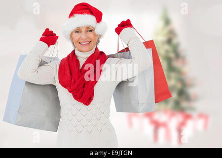 Image composite de l'ambiance festive woman holding shopping bags Banque D'Images