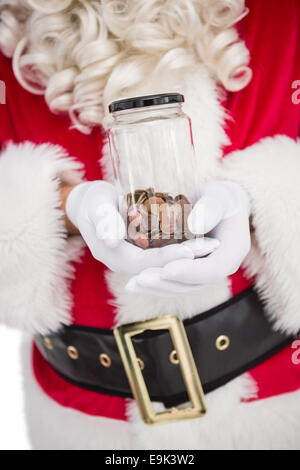 Santa holding pot plein de pièces d'un Banque D'Images