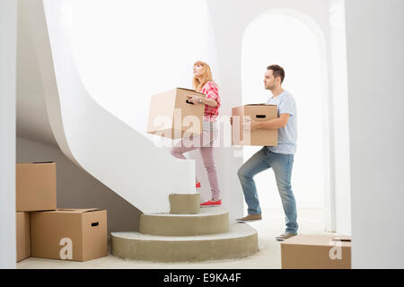 Couple de boîtes de carton vers le haut des escaliers in new house Banque D'Images