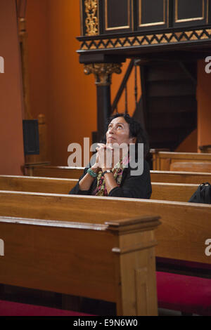 Femme profondément dans la prière dans une église catholique. Zielona Gora, Pologne. Banque D'Images