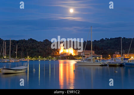 Portovenere, Ligurie, Italie. Voir au clair de lune à travers Harbour à l'allumé Santuario di Nostra Signora delle Grazie. Banque D'Images