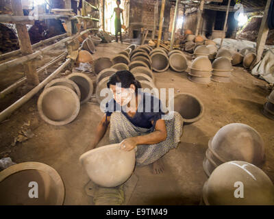 Twante, Division de Yangon, Myanmar. 2e Nov, 2014. Les travailleurs d'un polit l'intérieur des pots en argile dans une usine de poterie à Twante, Myanmar. Twante, à environ 20 milles de Yangon, est mieux connu pour sa poterie traditionnelle. Les décideurs de la poterie ont du mal à maintenir les travailleurs dans leurs cabanes. Le Myanmar s'ouvre à des investissements extérieurs et son économie se développe, les jeunes partent de Yangon à prendre des emplois mieux rémunérés dans l'industrie touristique ou dans les usines qui se multiplient autour de Yangon. © Jack Kurtz/ZUMA/Alamy Fil Live News Banque D'Images