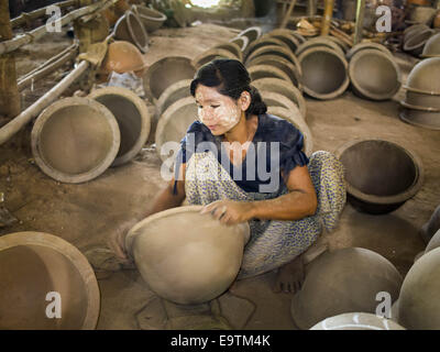 Twante, Division de Yangon, Myanmar. 2e Nov, 2014. Les travailleurs d'un polit l'intérieur des pots en argile dans une usine de poterie à Twante, Myanmar. Twante, à environ 20 milles de Yangon, est mieux connu pour sa poterie traditionnelle. Les décideurs de la poterie ont du mal à maintenir les travailleurs dans leurs cabanes. Le Myanmar s'ouvre à des investissements extérieurs et son économie se développe, les jeunes partent de Yangon à prendre des emplois mieux rémunérés dans l'industrie touristique ou dans les usines qui se multiplient autour de Yangon. © Jack Kurtz/ZUMA/Alamy Fil Live News Banque D'Images