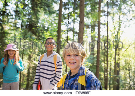Portrait of smiling boys and girl in woods