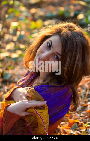 Young Pretty woman relaxing in the autumn park outdoor shot Banque D'Images