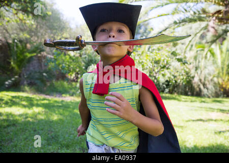 Young boy wearing Fancy Dress Costumes, running in park Banque D'Images