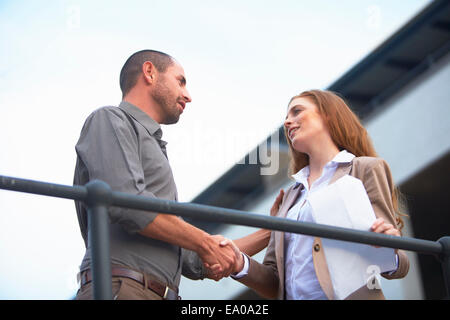 Homme d'affaires et business woman shaking hands Banque D'Images