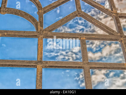 Grille de fer noir sur ciel nuageux ciel d'été : ligne droite crée des formes carré et triangle sur fond de ciel nuageux Banque D'Images