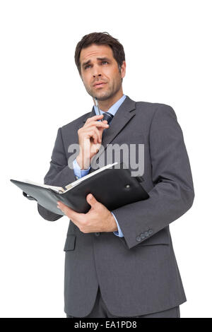 Handsome businessman holding son journal Banque D'Images