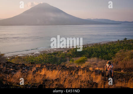 Une femme touriste marche sur le paysage côtier dans un espace de loisirs public à Waijarang, l'île de Lembata, Nusa Tenggara est, Indonésie. Banque D'Images