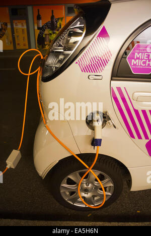 Voiture électrique en charge de nuit, quartier de Neukölln, Berlin, Allemagne de l'Est Banque D'Images