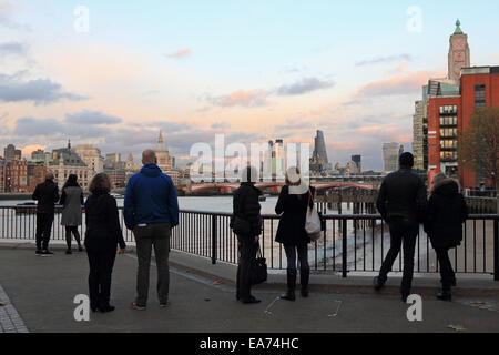 Londres, Royaume-Uni. 7 novembre, 2014. Au-delà de Blackfriars Bridge sur la Tamise, le soleil jette une lueur chaude sur la Cathédrale St Paul dans la ville de Londres, que des passants s'arrêter pour admirer la vue. Credit : Julia Gavin UK/Alamy Live News Banque D'Images