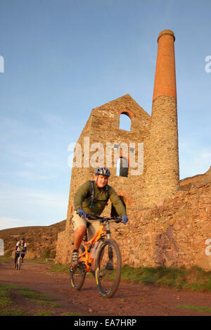 Cyclistes sur la côte en passant l'arbre du moteur de pompage d'Towanroath ruine maison partie de papule Coates tin mine sur le North Cornish Banque D'Images
