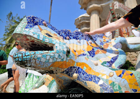 Barcelone - 12 juillet : les gens touchent le dragon dessiné par Gaudi au Parc Güell le 12 juillet 2013 à Barcelone, Espagne. Banque D'Images