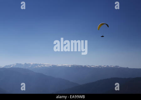 Un parapente deltaplane près du décollage du Azinha, à Manteigas, au Portugal, avec la Serra da Estrela enneigées en arrière-plan Banque D'Images