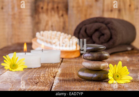 Les pierres de basalte zen spa avec de l'huile et des bougies sur le bois Banque D'Images