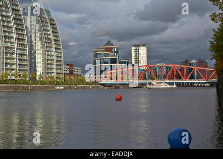 Appartements donnant sur l'eau à Salford Quay, MediaCityUK, Manchester sur un après-midi ensoleillé et lumineux, avec de gros nuages au-dessus Banque D'Images