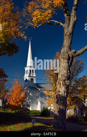 Les érables et église blanche avec tour de l'horloge à Peacham Vermont USA à l'automne matin avec ciel bleu Banque D'Images