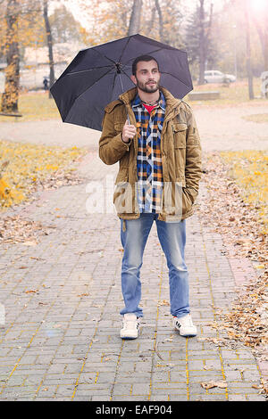 Man holding umbrella Banque D'Images