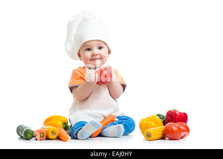 Bébé portant un chapeau de chef avec des légumes Banque D'Images