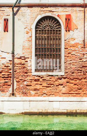 Vieille fenêtre avec des barres de fer rouillé, Venise Italie. Banque D'Images