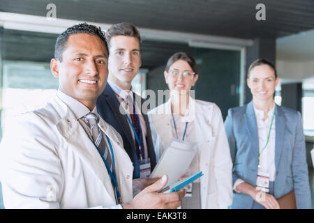 Les scientifiques et les gens d'affaires smiling in laboratory Banque D'Images