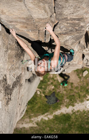 Fille italienne monte a 6b route de crack dans Balmanolesca, la plus historique en granite crag Ossola. Varzo, Italie. Banque D'Images