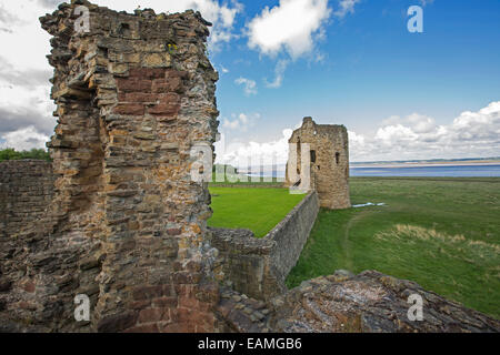 Ruines du 13e siècle château sur le bord de l'estuaire de la rivière Dee sous ciel bleu barbouillé de nuages dans le nord du Pays de Galles Banque D'Images