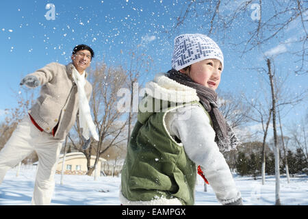 Père et fils dans la batailles de boules de neige Banque D'Images