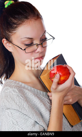 La jeune fille dans le vieux livre et une pomme sur un fond blanc Banque D'Images