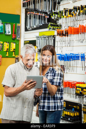 Family using tablet computer in hardware store Banque D'Images