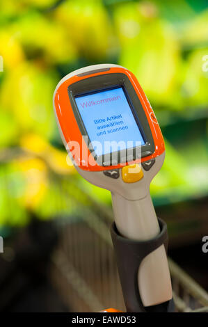 Un terminal mobile Subito self-scanning device fixé sur un panier dans un supermarché Migros à Zurich, Suisse. Banque D'Images