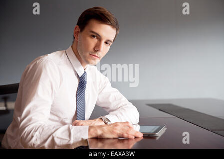 Businessman using digital tablet in office Banque D'Images