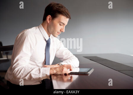 Businessman using digital tablet in office Banque D'Images