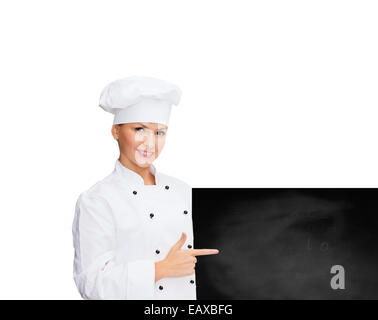 Female chef avec white blank board Banque D'Images