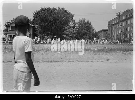 En 1959, une grande foule marche du Capitole de l'État de l'Arkansas au Central High School de Little Rock, démontrant l'opposition intense à l'intégration de l'école. L'événement a eu lieu pendant le mouvement des droits civiques, marquant un moment charnière dans la lutte pour l'égalité raciale aux États-Unis. Banque D'Images