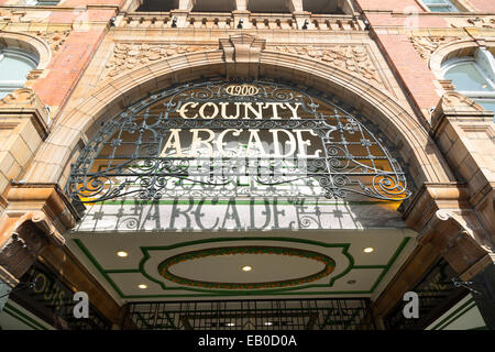 UK, Leeds, Rue Briggate, comté Arcade signe. Banque D'Images