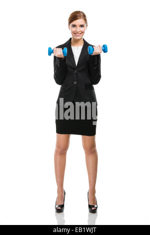 Belle et jeune business woman lifting weights and smiling, isolé sur fond blanc Banque D'Images