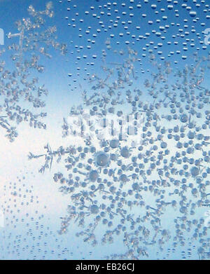 Des cristaux de glace se forment sur la fenêtre d'un avion en vol Banque D'Images