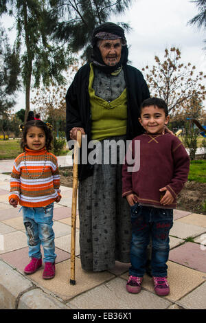 Femme kurde syrienne orthodoxe de tatouages sur son visage et ses petits-enfants, Erbil, Province d'Erbil, Irak, Kurdistan irakien Banque D'Images