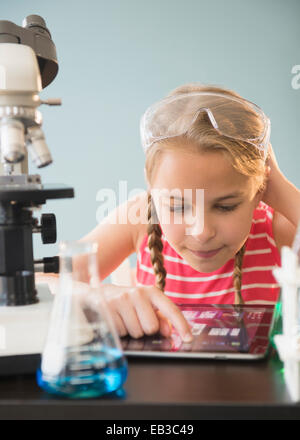 Caucasian girl using digital tablet in science lab Banque D'Images