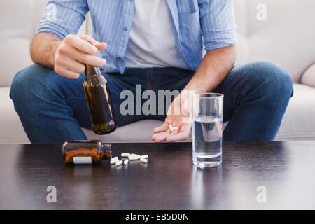 Close up of man showing pills et holding bottle Banque D'Images