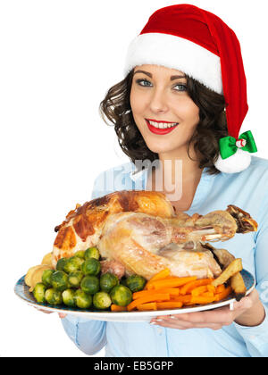 Jeune femme en rouge Santa Hat Holding Rôti de dindon et de légumes prêts à manger pour le déjeuner de Noël isolé sur fond blanc Banque D'Images