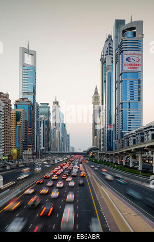 Vue en soirée des gratte-ciel et le trafic le long de la route Sheikh Zayed à Dubaï aux Émirats arabes unis. Banque D'Images