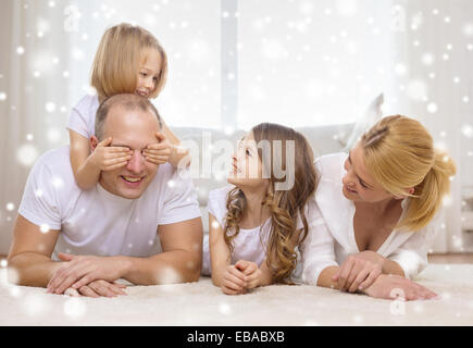 Smiling parents et deux petites filles à la maison Banque D'Images