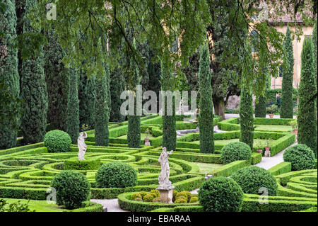 Dans les jardins Renaissance formels du Giardino Giusti, Vérone, Italie. Une vue verdoyante de cyprès, haies de boîtes coupées et statues Banque D'Images