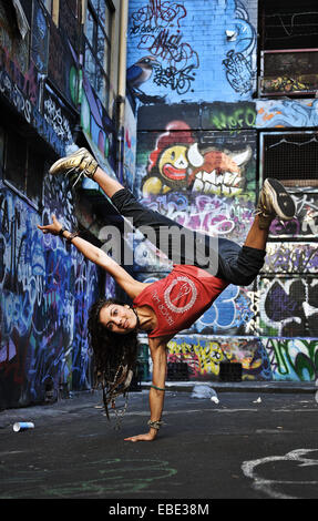 Une grande danseuse et le retournement des coups dans une rue latérale couverte de graffiti dans la région de Melbourne, Victoria, Australie Banque D'Images
