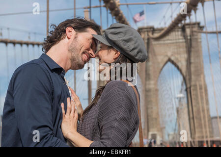 USA, l'État de New York, New York City, Brooklyn, heureux couple kissing on Brooklyn Bridge Banque D'Images