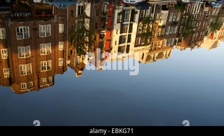 Rangée de maisons historiques reflétées dans un canal tranquille sous ciel clair à Amsterdam, Hollande du Nord. Pays-Bas, Europe Banque D'Images