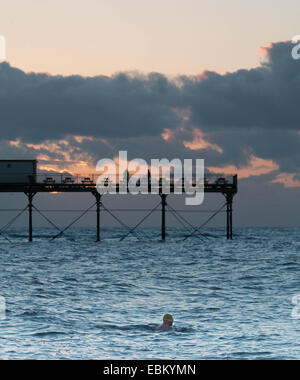 Aberystwyth, Pays de Galles, Royaume-Uni, 2 décembre 2014. Météo : une dame va pour une baignade au coucher du soleil à Aberystwyth comme temperates commencent à tomber. Crédit : Jon Freeman/Alamy Live News Banque D'Images